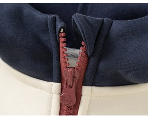 Close-up of contrast knit jacket featuring a red-brown zipper with INS BOBO engraving