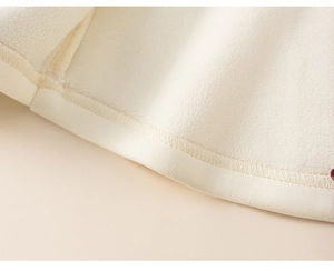 Detail of the thick polar fleece lining and fine stitching on children sweater