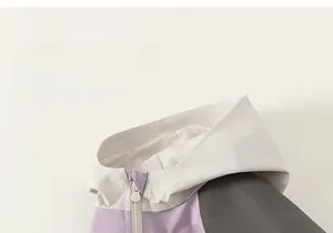 Close-up of color-block windproof hooded jacket with high collar and zipper detail