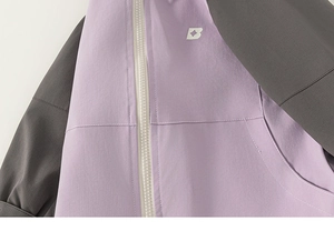 Detail of lavender and grey outdoor jacket with white resin zipper and logo print