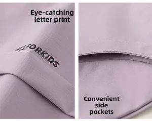 Detail of lavender kid's outdoor jacket with grid texture, logo print, and side pockets