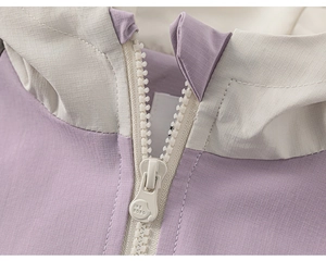 Detail of tear-resistant grid fabric and white zipper on girls' outdoor hooded jacket