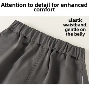 Detail of boys dark grey cargo pants featuring a comfortable elastic waistband