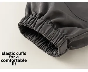 Detailed close-up of elastic ribbed cuffs on dark grey boys' cargo pants