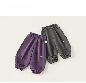Detail of cargo pants showing elastic ankle cuffs and knees with overlapping fabric seams