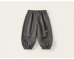 Detail view of dark grey kids cargo pants featuring elastic waist and tapered cuffs