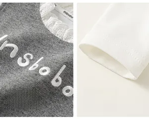 Détail de vêtement pour fille avec broderie INSbobo et finitions de col en dentelle fine