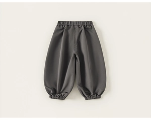 Detail of dark grey kids cargo pants featuring elastic waistband and cuffed ankles