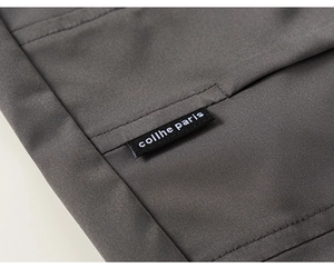 Close-up of deep gray fabric texture and premium woven brand label on boys cargo pants