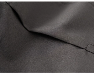 Close-up of durable dark grey high-density fabric and stitching on boys' cargo pants