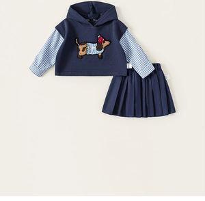 Detail of navy hooded faux two-piece top with dachshund embroidery and pleated skirt