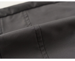 Detailed macro view of dark grey fabric texture and neat stitching on boys cargo pants
