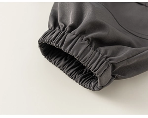Macro detail of dark grey elastic cuffs with fine stitching on boys cargo pants
