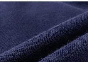 Close-up detail of dark blue knitted fabric showing high-density flat needle texture