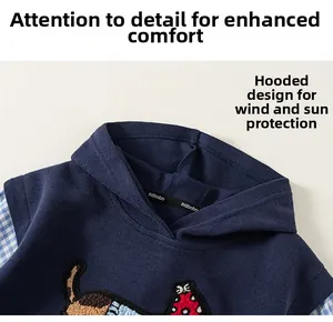 Detail of navy blue hoodie with embroidered puppy patch and blue plaid sleeve stitching