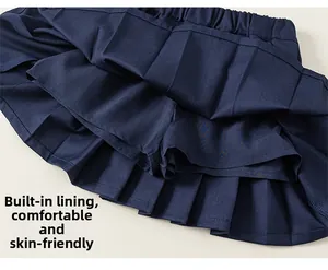 Navy blue pleated school skirt detail showing the built-in safety lining and fabric texture