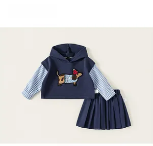 Detail of navy blue hoodie with dog embroidery and matching pleated skirt set for girls