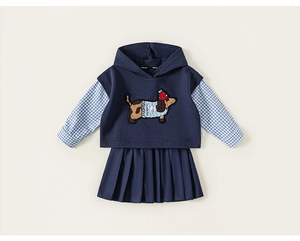 Detailed view of kids navy blue vest with cute dachshund patch and plaid pleated skirt