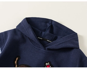 Detail of navy blue hoodie featuring cartoon embroidery and branded inner neckline