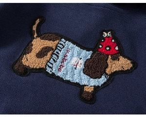 Detail of dachshund embroidery with towel stitching on navy blue children sweatshirt