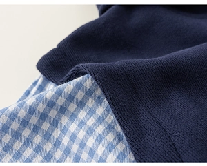 Detailed view of navy knit fabric stitched with blue and white gingham shirt material