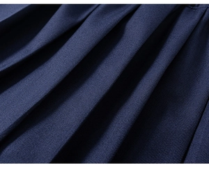 Macro detail of navy blue pleated skirt fabric with twill weave and sharp pleats