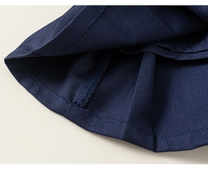 Close-up of navy blue twill fabric detail with high-quality stitching on children's skirt