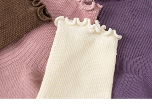Detail of soft cotton kids socks featuring delicate ruffle edges and knitted texture
