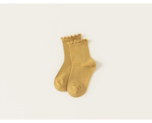 Detail showing mustard yellow ribbed knit texture and ruffled edges of these soft socks