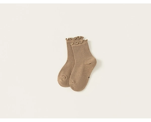 Close-up of coffee brown ribbed cotton socks featuring delicate ruffled edges and letter M