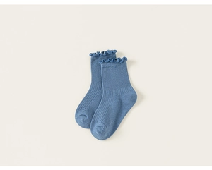Detail of denim blue ribbed children's socks featuring stylish ruffled lettuce edges