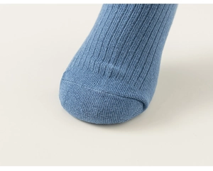 Macro shot of blue ribbed cotton socks showing seamless toe stitching and soft knit fabric