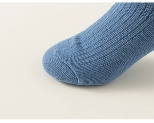 Detail shot of blue cotton mesh knit socks with seamless toe and fine ribbing texture