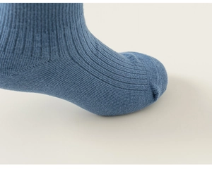 Close-up of dark blue cotton knit socks with ribbing and flat seamless toe seam