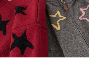 Detail of baby boys knit cardigan featuring star patterns and premium metal zipper closure