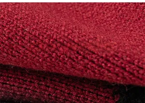 Close-up of soft red knit fabric texture showing high-quality wool blend material
