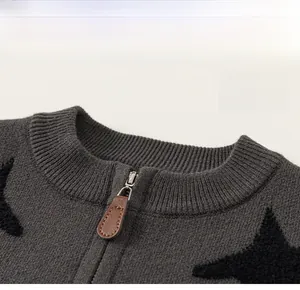 Detailed view of dark grey knit cardigan with classic crew neck and black star patterns