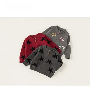 Detailed flat lay of three boys' knitted cardigans with star patterns and zip closures