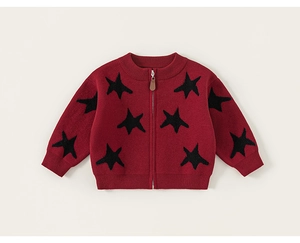 Detailed close-up of kids red knit cardigan featuring black stars and a brown leather zipper