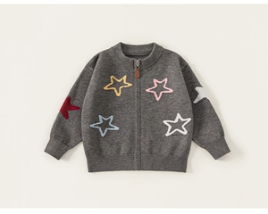 Detailed macro view of dark grey knit cardigan with colorful stars and metal zipper pull