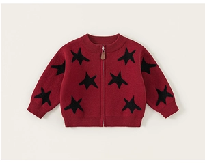 Detailed view of kids red knitted cardigan with black stars and a front zipper closure