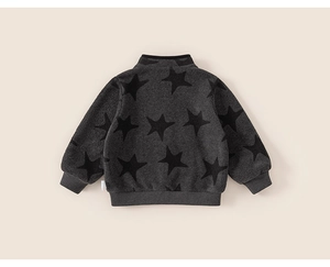 Detail of soft fleece fabric texture on a gray toddler jacket with black star pattern