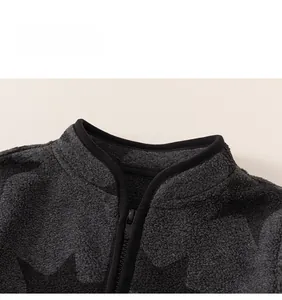 Detail of grey fleece kids cardigan with star pattern and durable zipper closure
