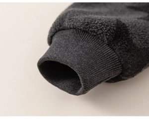 Detailed macro view of dark grey thick fleece sleeve with elastic ribbed knitted cuffs