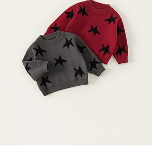 Detail of star pattern jacquard on gray and burgundy knitted sweaters for boys