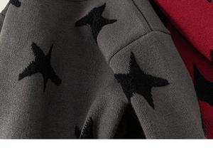 Detailed close-up of knitted star patterns on grey and red toddler sweaters