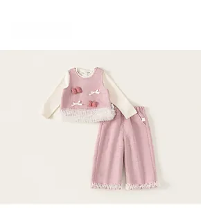 Detailed flat lay of a girls pink tweed 3-piece set with lace trim and bow details