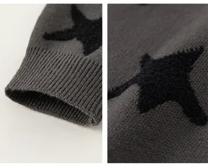 Close-up of ribbed cuffs and soft star jacquard texture on dark grey knit sweater