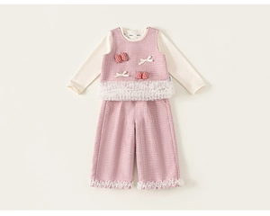 Close-up of pink tweed vest with bow details and layered mesh ruffles for little girls