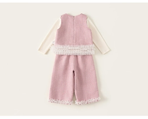 Detail view of pink tweed vest and trousers set with white mesh ruffles for little girls
